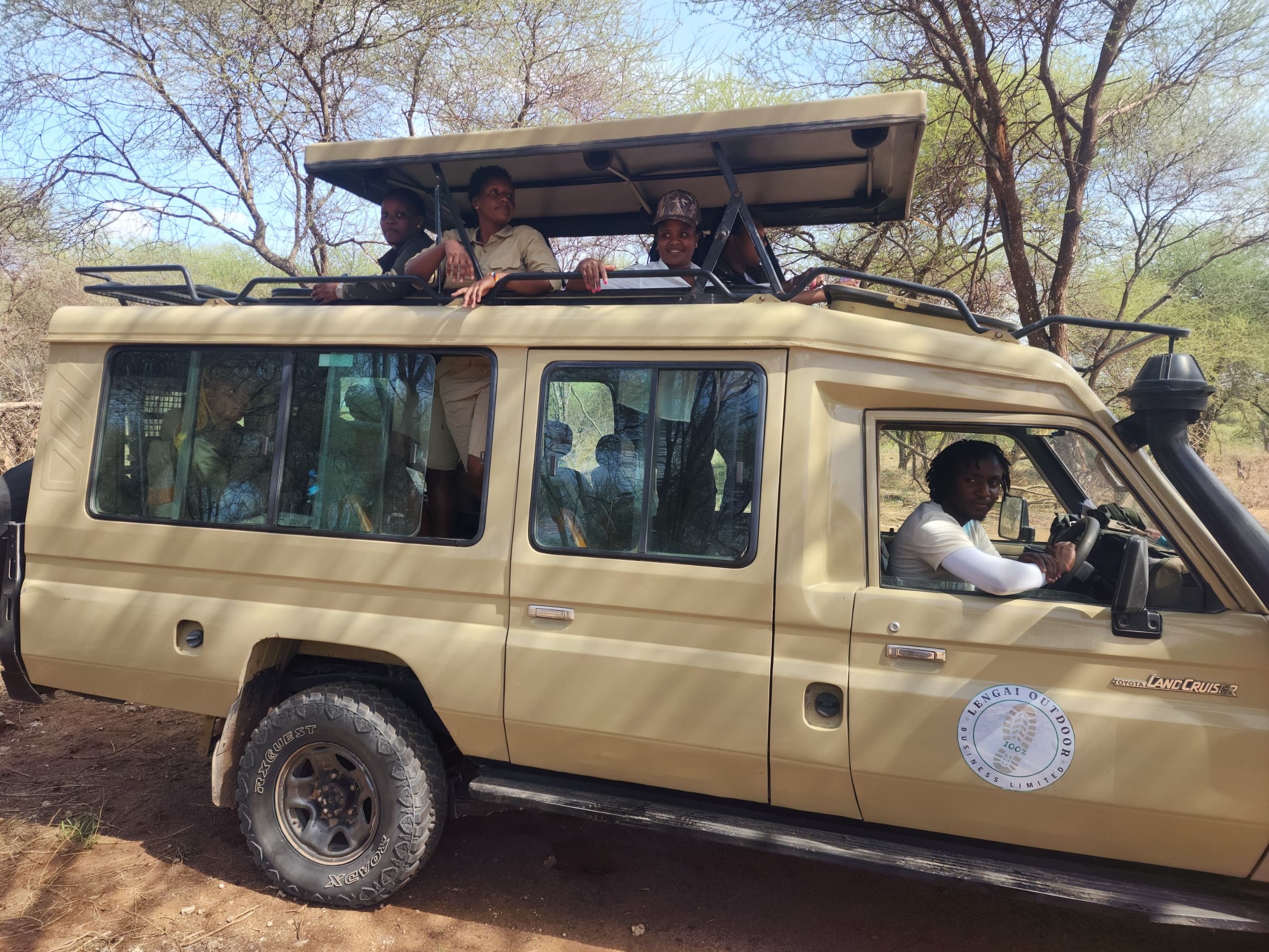 Lengai safari branded vehicle with travelers
